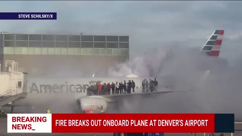 American airlines plane catches fire at denver international airport