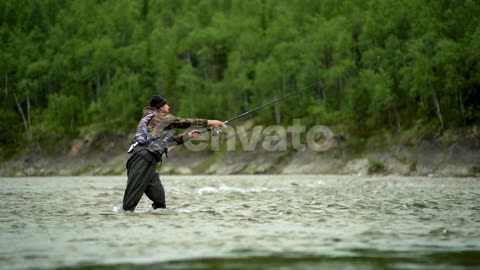 A Fisherman Casts A Spinning Rod And Catches Fish On A River