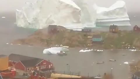 Incredible timelapse of a massive iceberg drifting past Innaarsuit village in Greenland!