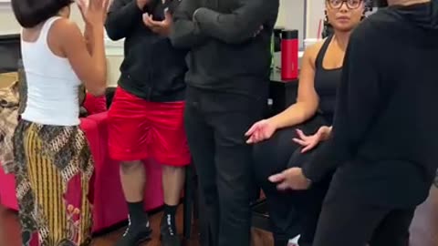 A GROUP OF BLACK PEOPLE TALKING AND THEN THEY HEAR A NOISE