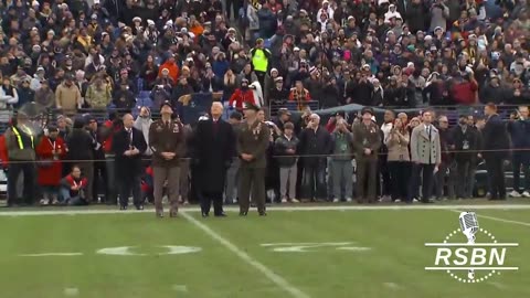 President Donald J Trump walks onto the field and salutes