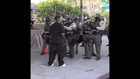 A protestor threw a can at a cop and was tackled to the ground by a bystander in Los Angeles. 🤣🤣