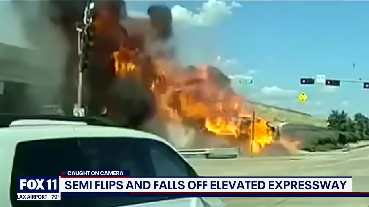 18-wheeler flips over barrier; Driver killed in fiery crash