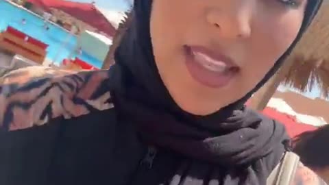 She complains because in Morocco they don't allow her to wear a hijab on beach.