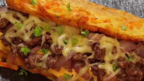 Make a dinner recipe, a potato and carrot pancake filled with beef and melted cheese,