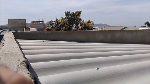 Roof already finished, screens screwed, rainwater collection gutters in place