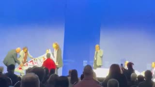CodePink protesters rush stage with banner as Secretary of the Navy and Palantir's