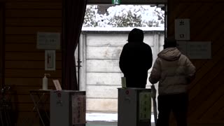 Voters in Japan head to the polls for snowy snap election