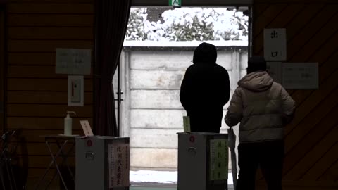 Voters in Japan head to the polls for snowy snap election