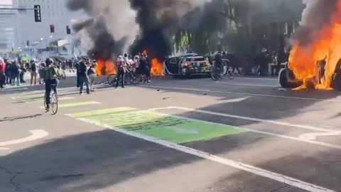 Rioters burn cars in Los Angeles