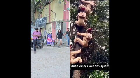 A boy bumps into a door. Meanwhile, several people are climbing a tree.