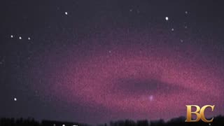 Photographer captures eerie red halo hovering over the Italian Alps