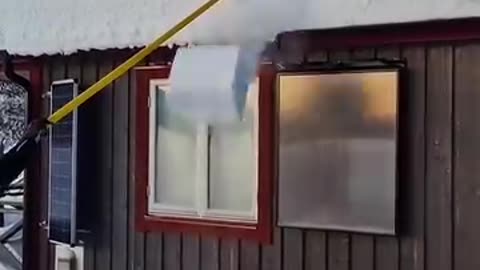 Snow falling on the roof
