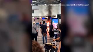 Travelers flee as fire breaks out at Milan airport
