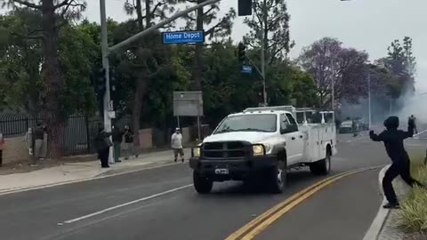 Protesters throwing rocks at cars in California…