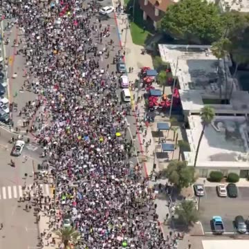 Protestors seen walking the streets of San Diego to protest ‘King’ Trump