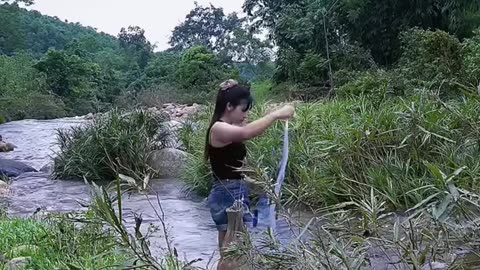 Beautiful girl throw net river to catching fish