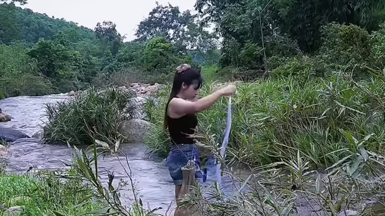 Beautiful girl throw net river to catching fish