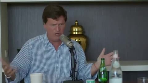 Tucker Carlson sporting a red Kabbalah bracelet while pushing the idea of white replacement