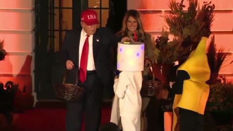 President Trump places candy on Child’s head