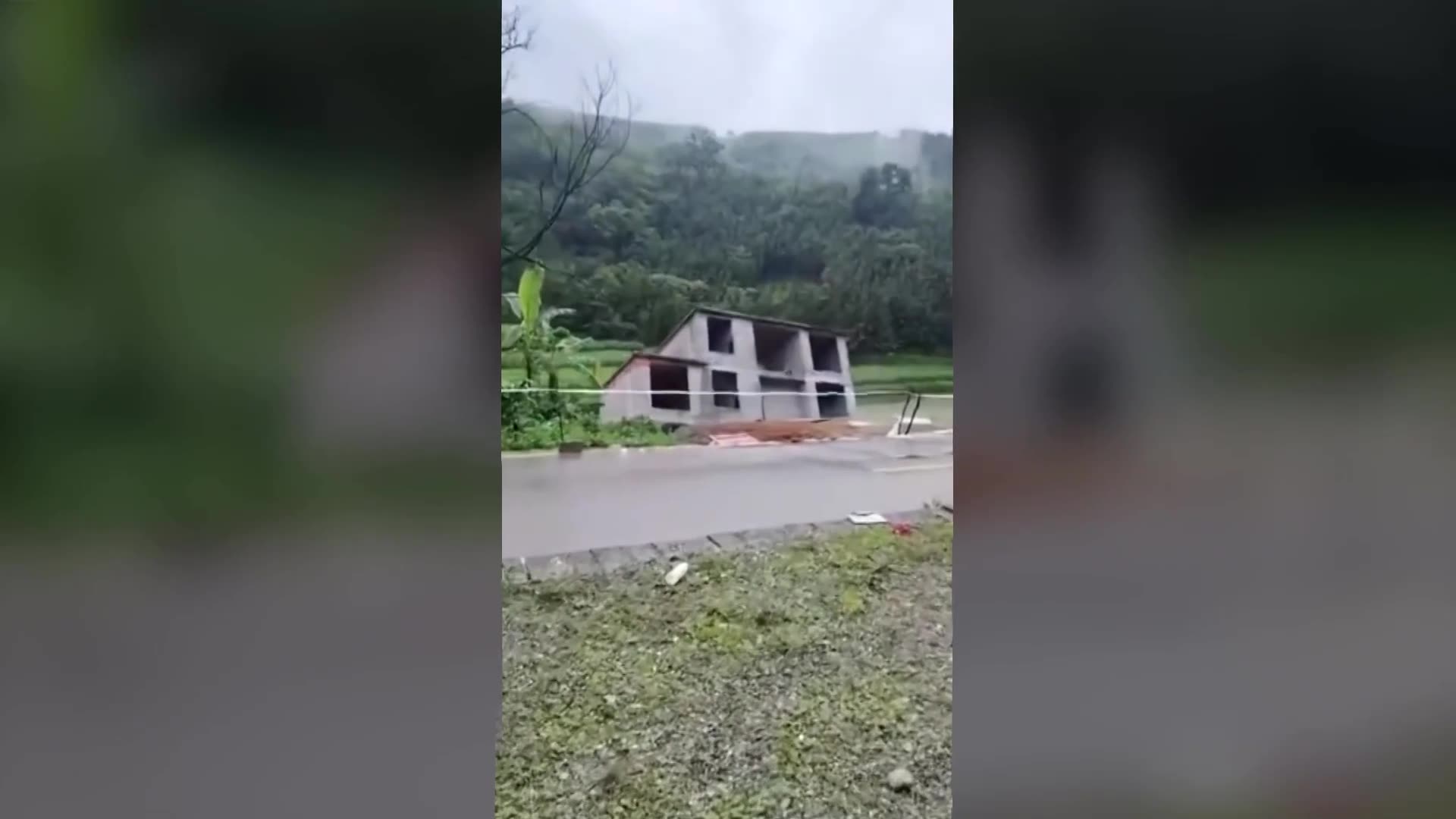 Building collapses into river as floods hit southern China