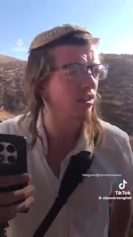 Armed Israeli settlers draining Palestinian water tank