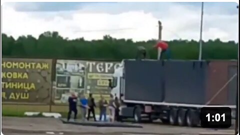 BREAKING: Video shows Russian men climbing onto a truck launching Ukrainian drones in an attempt to stop them from taking off.