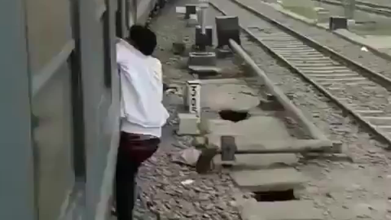 A snatcher was snatching a passenger's phone from a moving train...