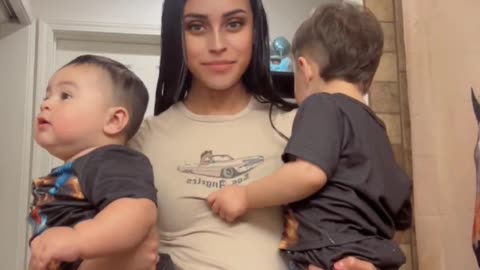 Mother of two kids shows the difference in size between her formula fed baby and