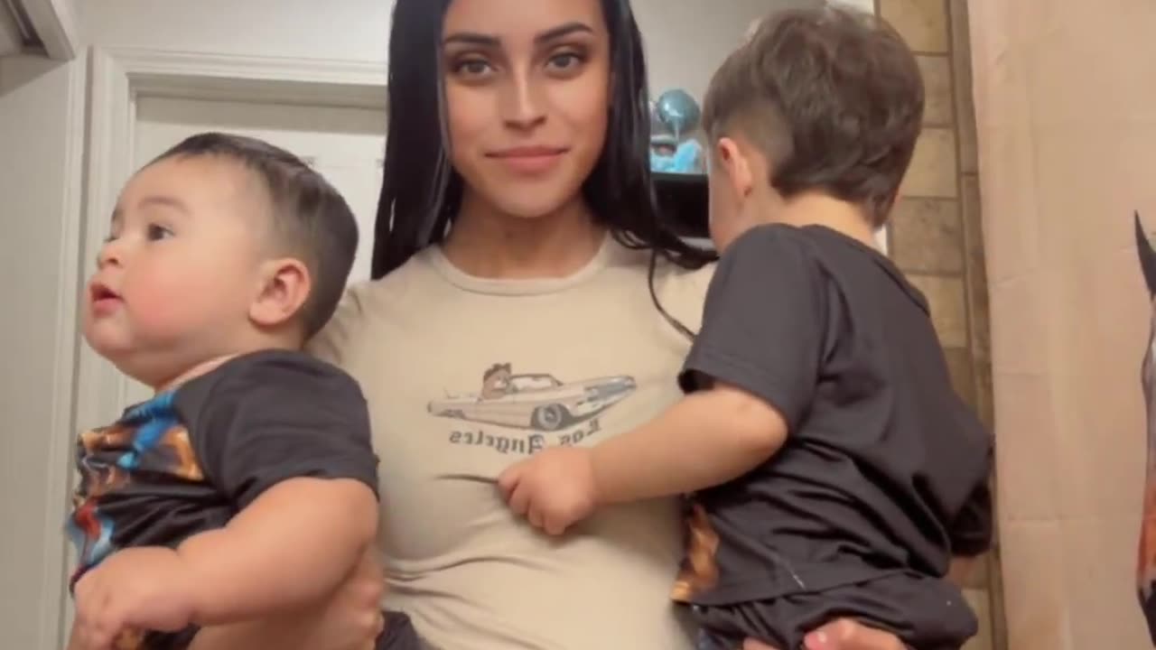 Mother of two kids shows the difference in size between her formula fed baby and
