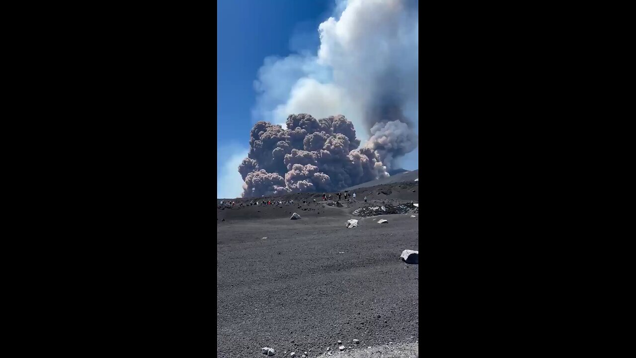 Tourists are forced to flee as Mount Etna erupts, sending a huge column of smoke into the sky.