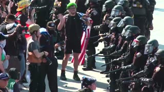 Protesters and police officers face off on LA freeway