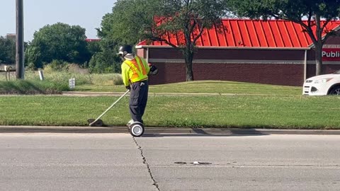 Landscaper Whacks Weeds on a Segway
