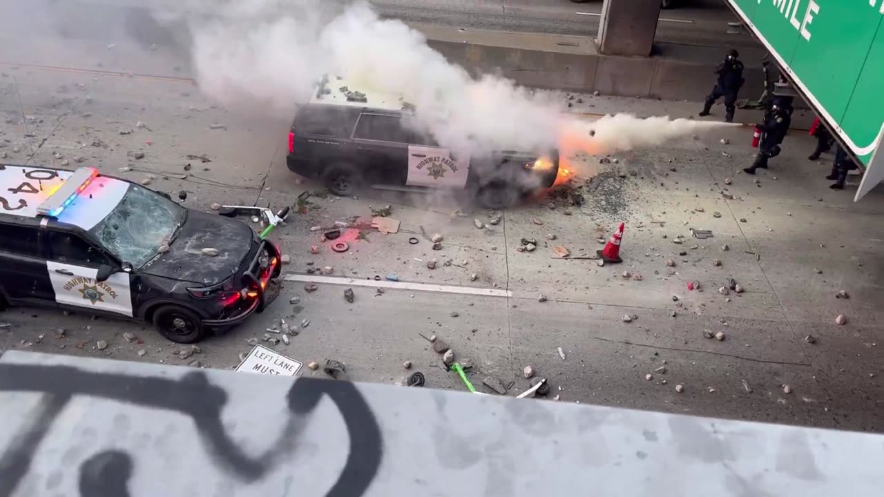 Rioters set police cruiser on fire