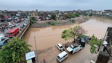Rescuers on standby near swollen river in Pakistan after heavy rain