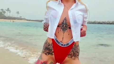 Hot tattooed milf on the beach