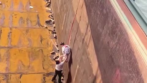 Check out this dad lowering his son on a big ship!.hd