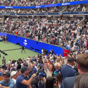 President Donald J. Trump signs supporters' hats at the US Open