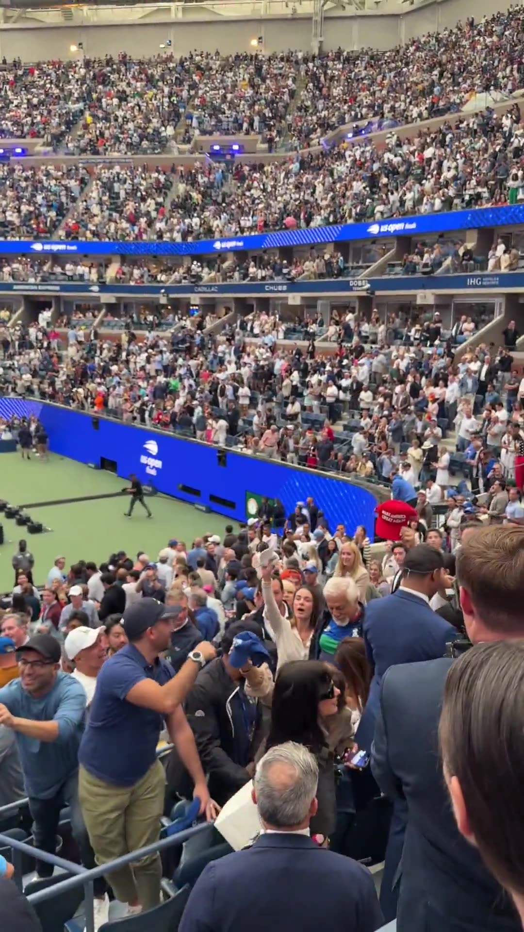 President Donald J. Trump signs supporters hats at the US Open