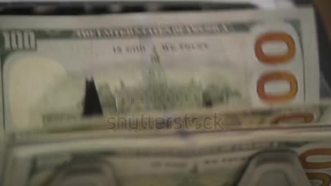 Close-Up of 100 Dollar Bills Moving Through Money Counter