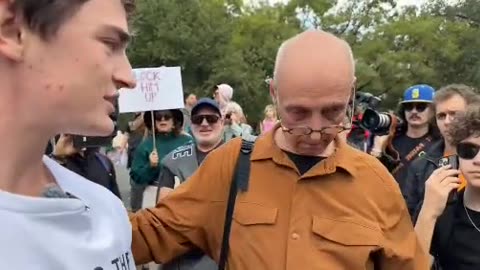 Evil nutjob follows Nick Shirley around with a sign celebrating the assassination of #CharlieKirk