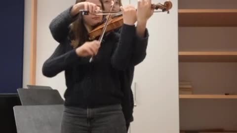 Two Musicians Perform on Single Violin