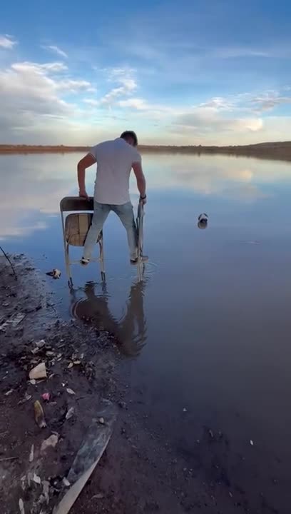 Man Uses Folding Chairs To Cross Water