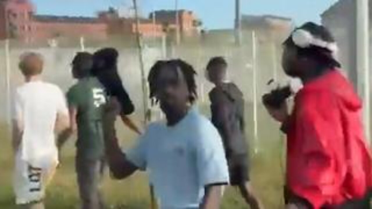 A lone white kid is chased and attacked by a group of black kids in Dublin, Ireland.