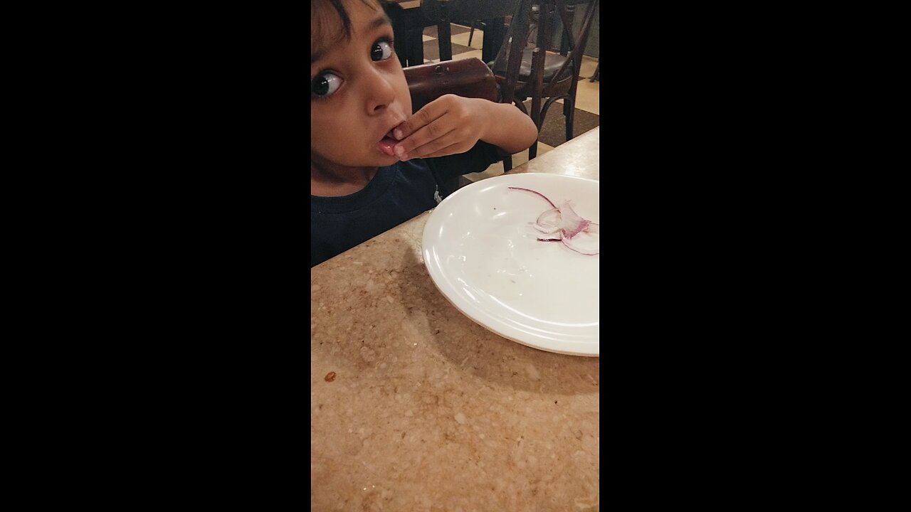 child eating onion 🧅