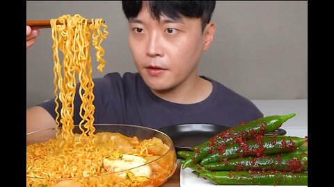 A big bowl of instant noodles, soybean paste and green peppers,