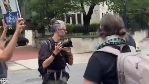 Pro-Palestinians surround the vehicle of an elderly man in DC and begin violently harassing him
