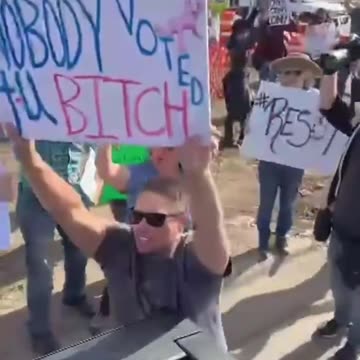 Fearless Alex Jones Confronts Tesla Protesters to Their Faces From the Back of a Cybertruck