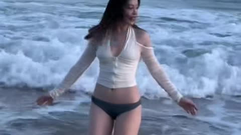 Beautiful girl surfing at the beach