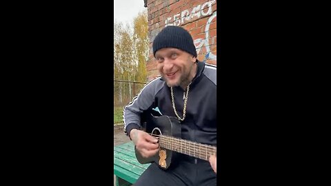 Russian man singing and playing guitar